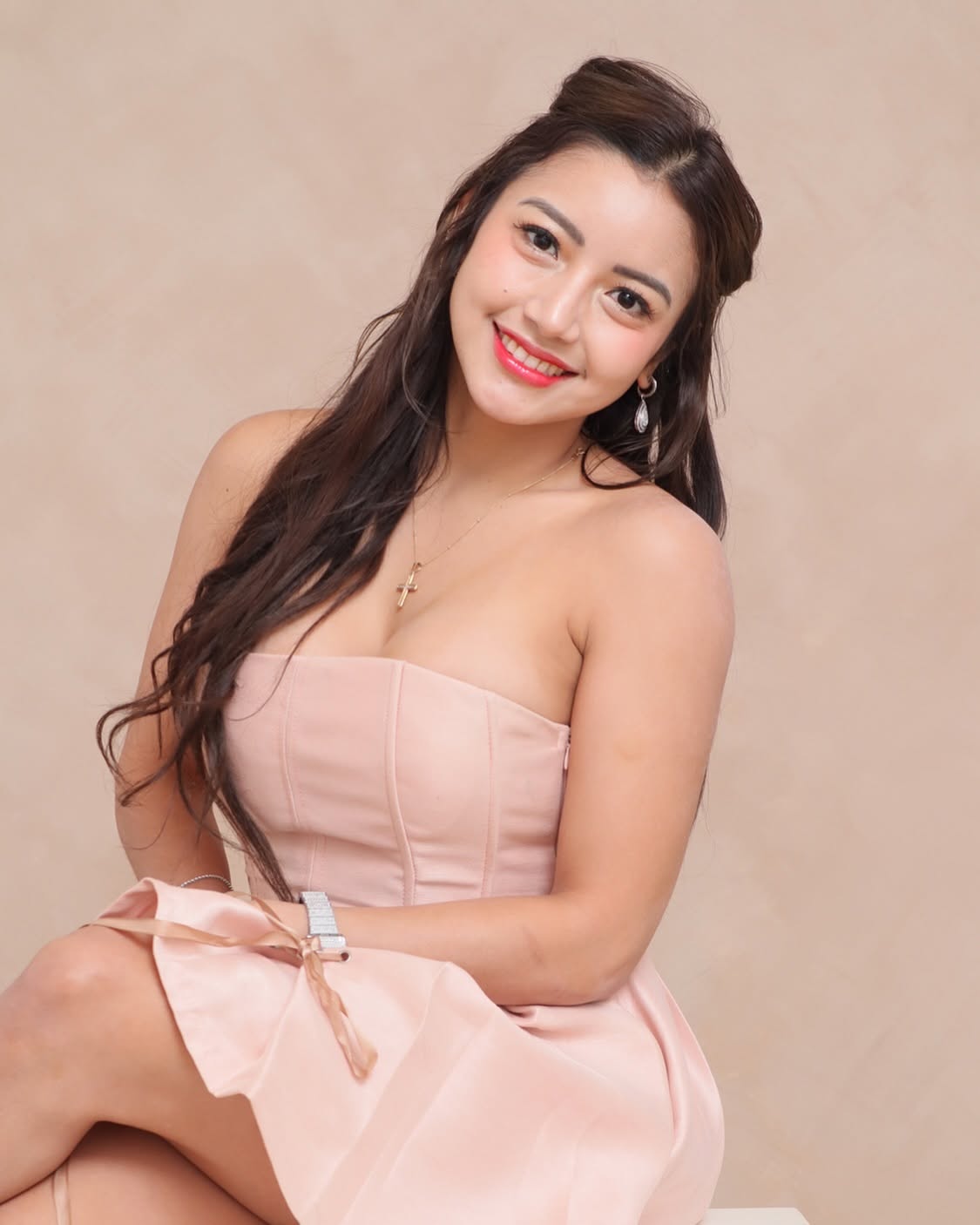 Claire smiling in a pink dress